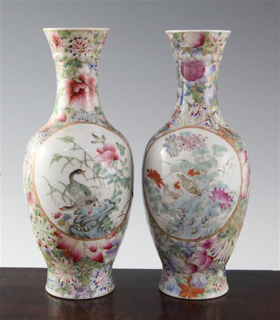 A pair of Chinese famille rose millefleur bottle vases, early 20th century, 24.5cm